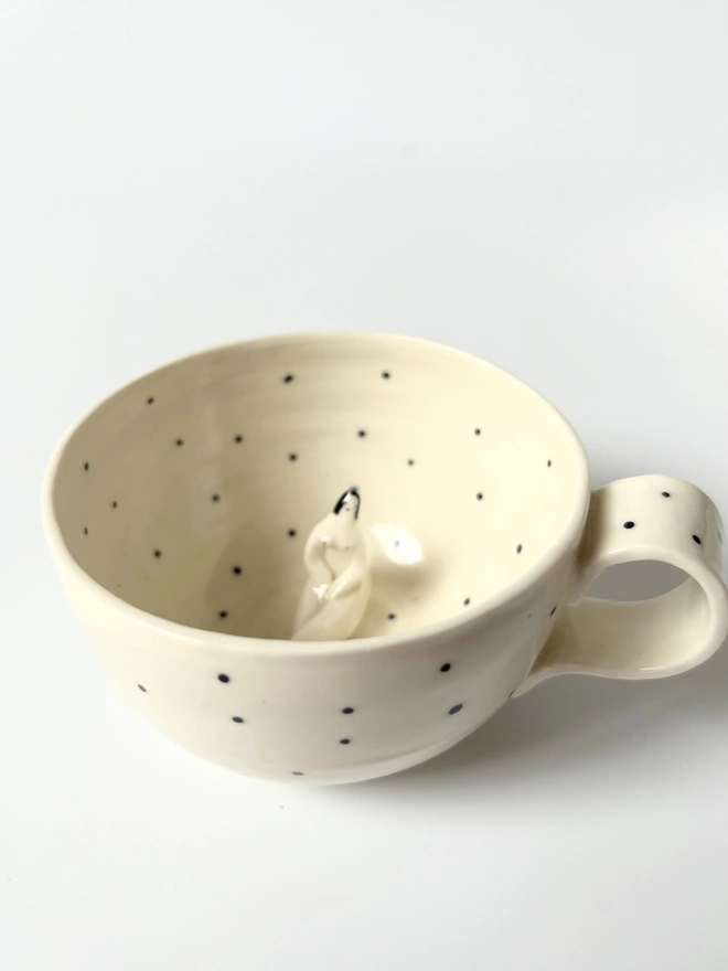  White Porcelain Cup With a Little Figure Sitting