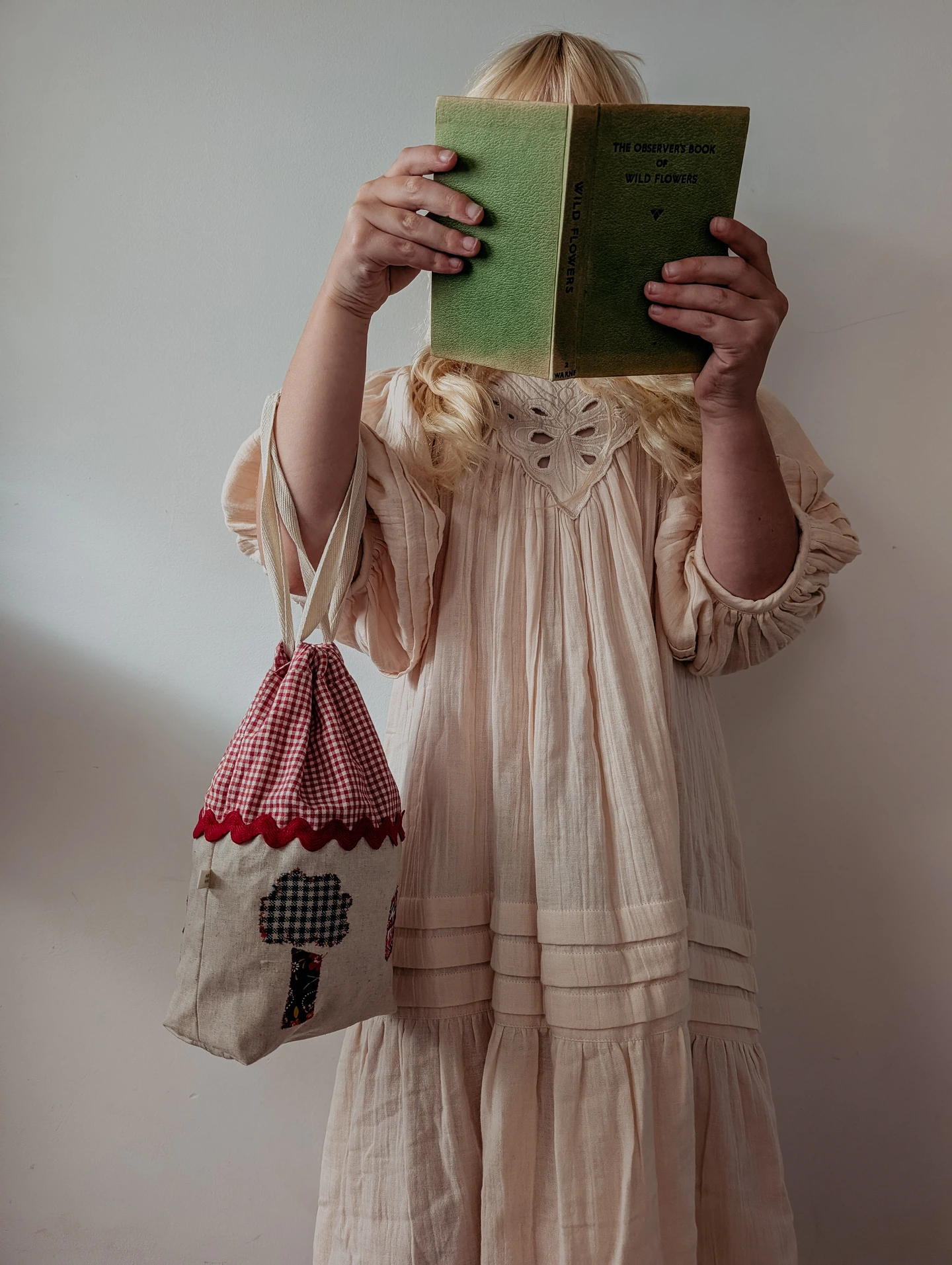 Little girl and her bag reading a book
