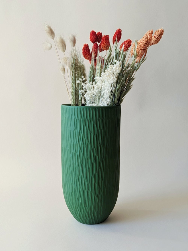 handmade textured dark green vase with dried flowers