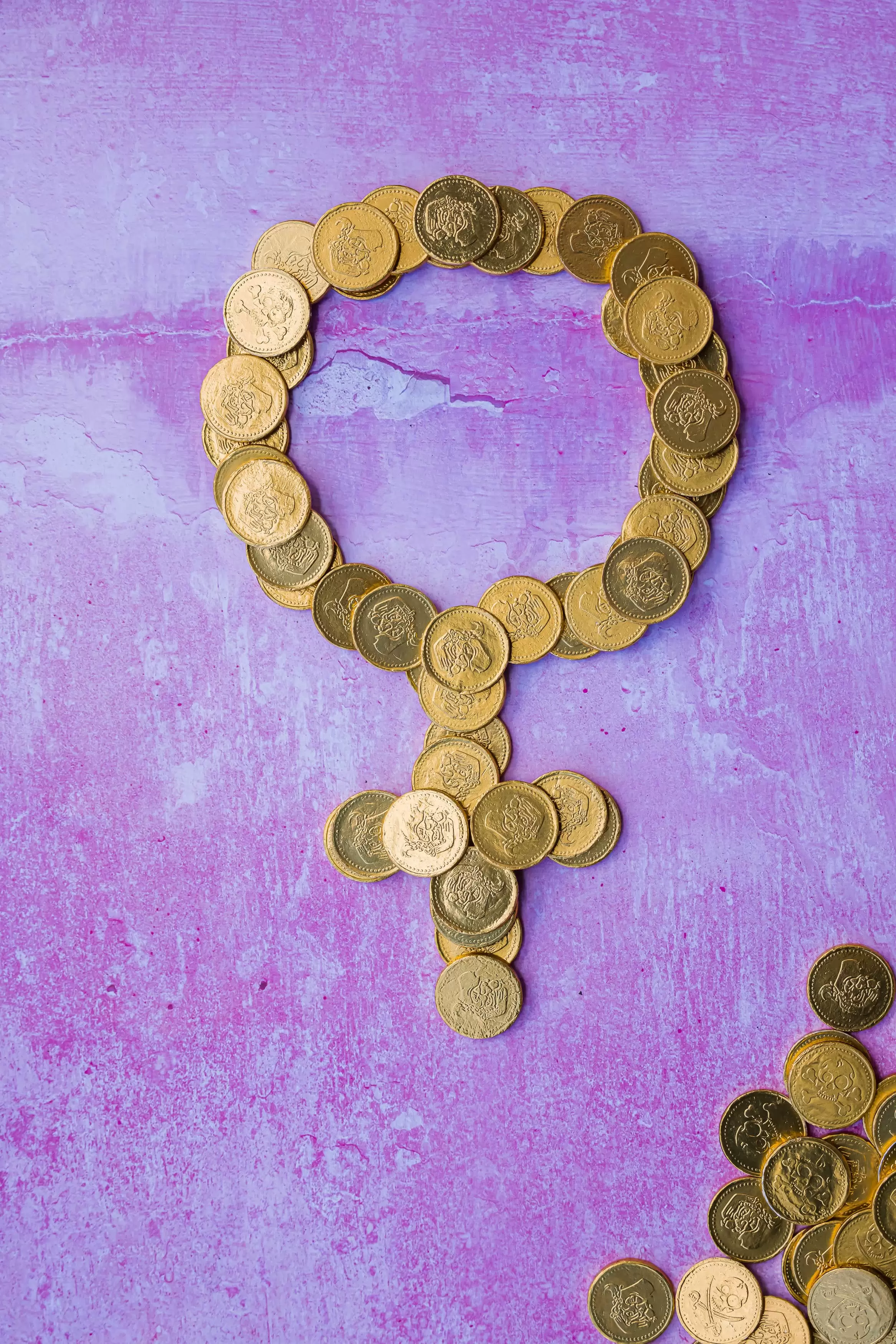 Female symbol in gold coins and purple background