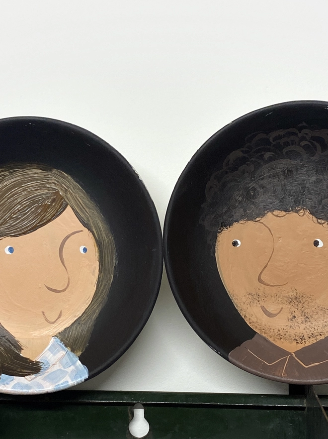 pair of plate portraits with girl and boy