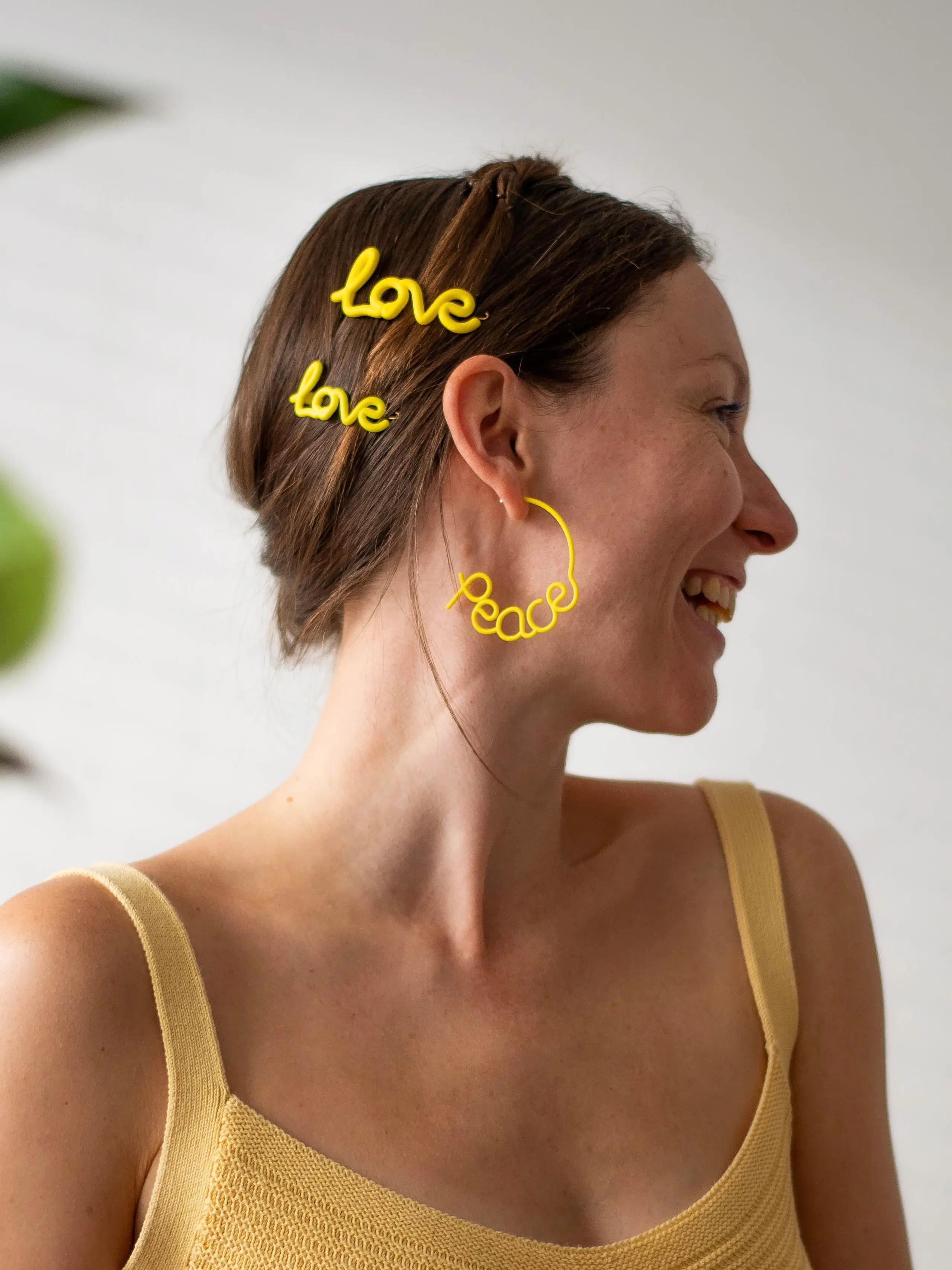 Portrait of Zoe Sherwood wearing yellow Love Peace hair accessories and jewellery