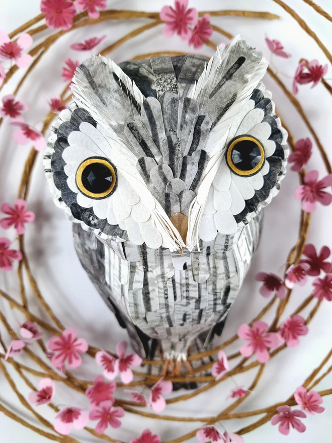 close up of a white faced owl sculpture