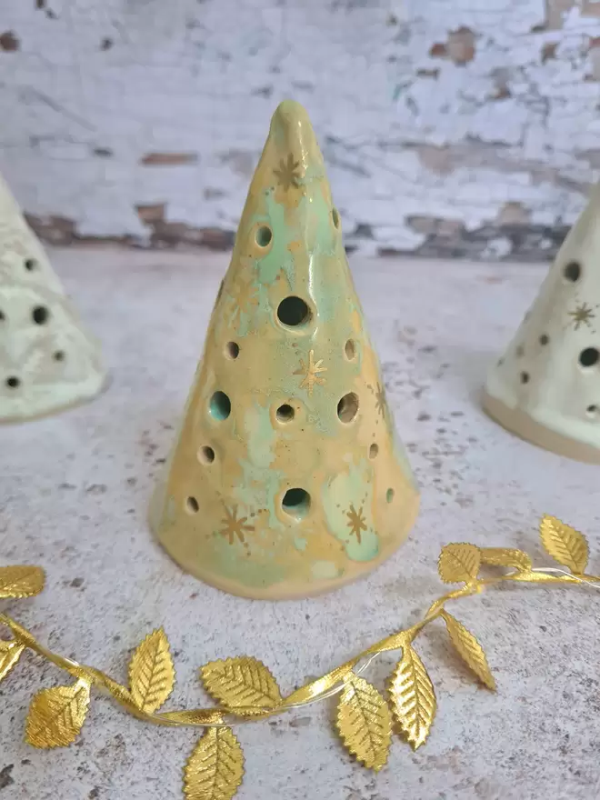 Ceramic christmas tree tea light holder, clay, pottery, Christmas decor, mantlepiece decor, christmas decoration, white with gold details, photographed with a gold star and gold leaves