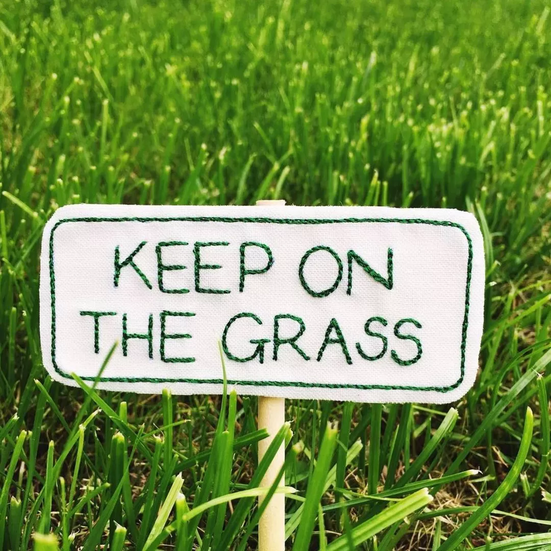 Keep on the grass sign by Emma Giacalone