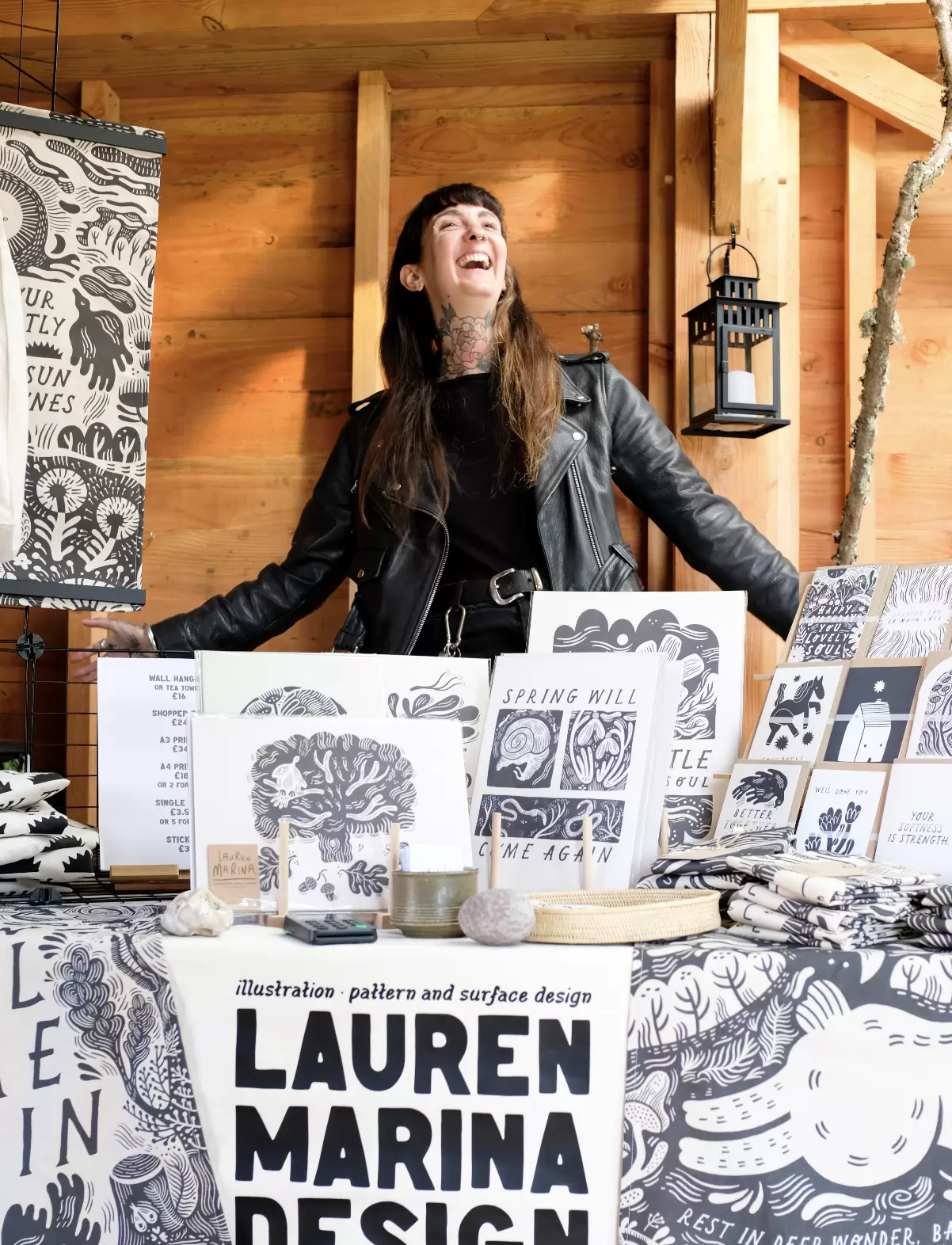 Illustrator Lauren Marina proudly displays her illustrated goods at a local makers market