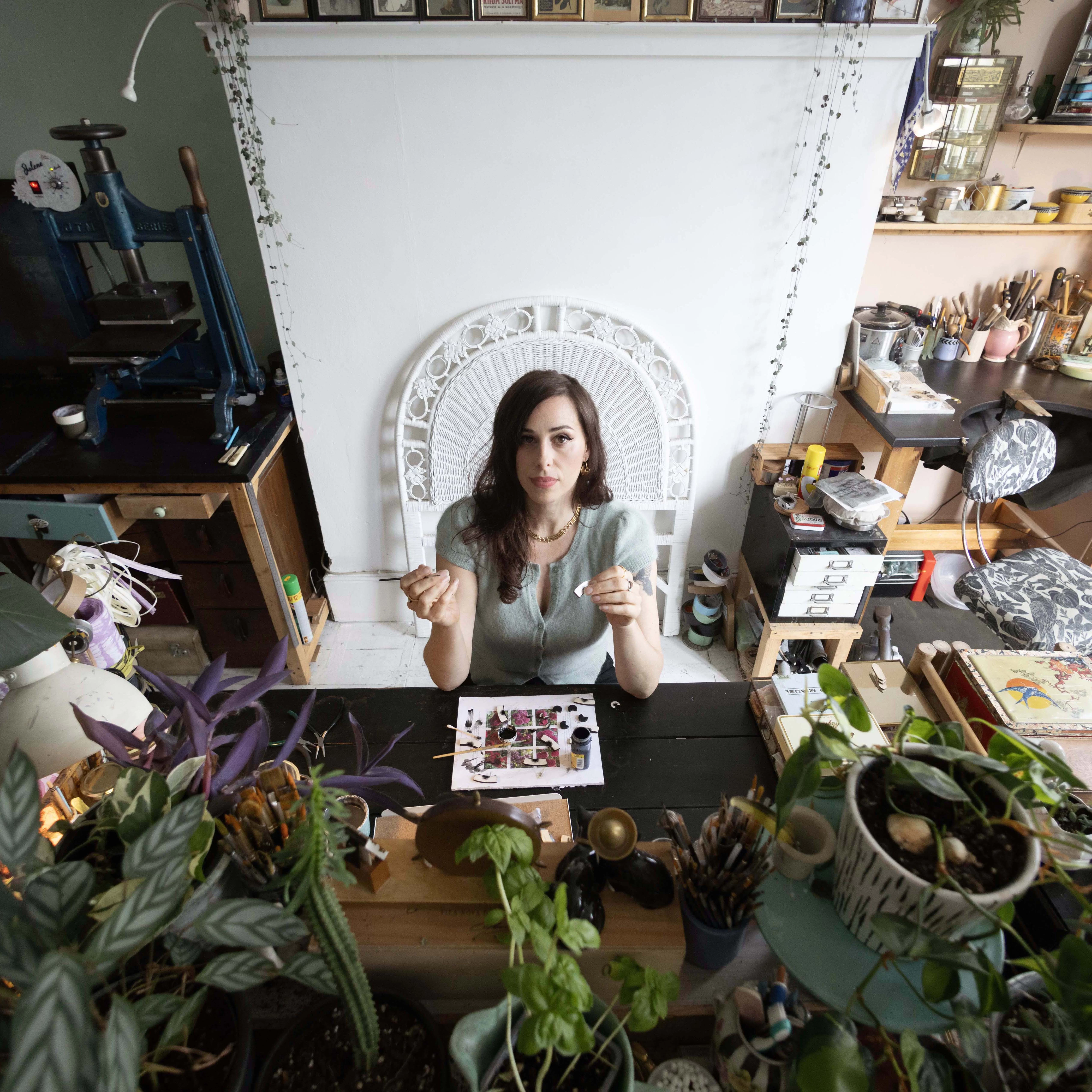 Rowenna, Founder of Rosita bonita, sitting at desk in her studio