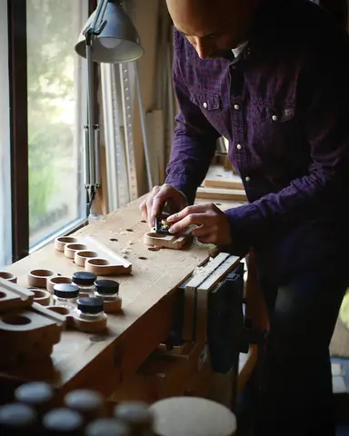 Vipul carving wood in a studio