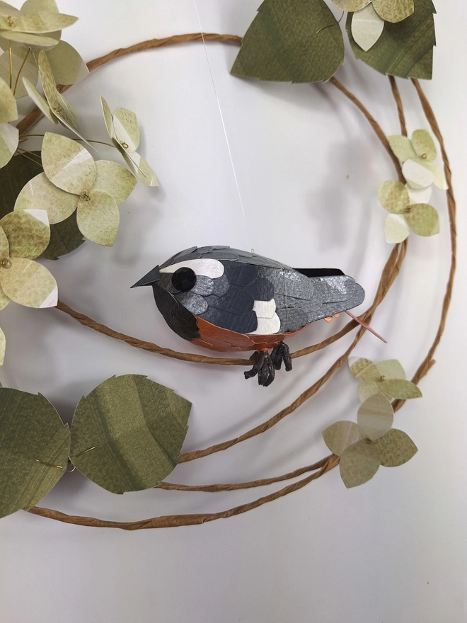 close up of a handmade redstart paper sculpture