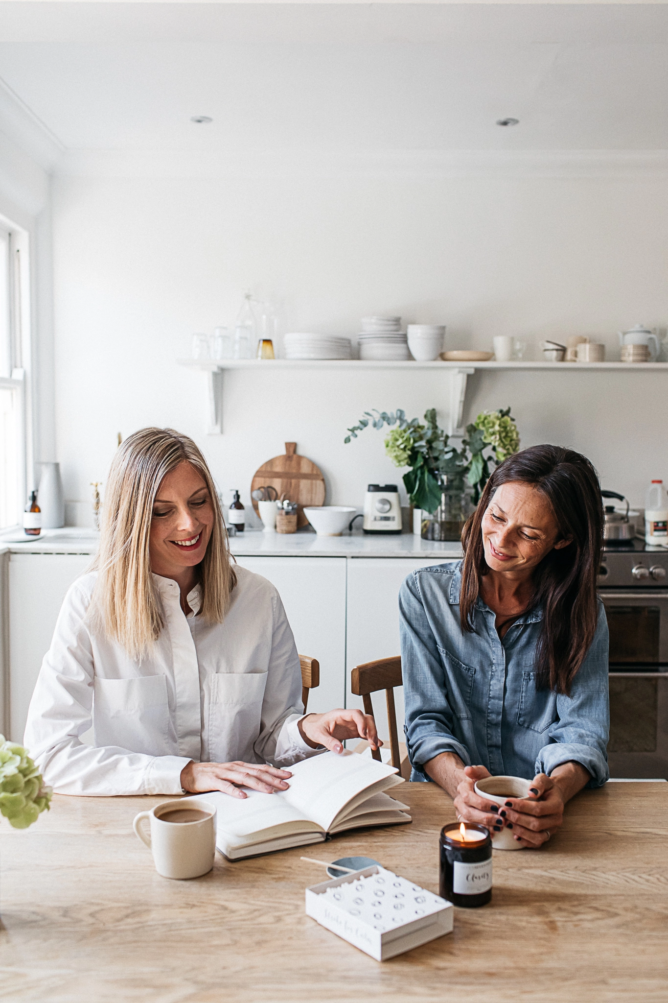 SevenSeventeen storefront image - Sarah and Naomi working on their kitchen table-founded candle business