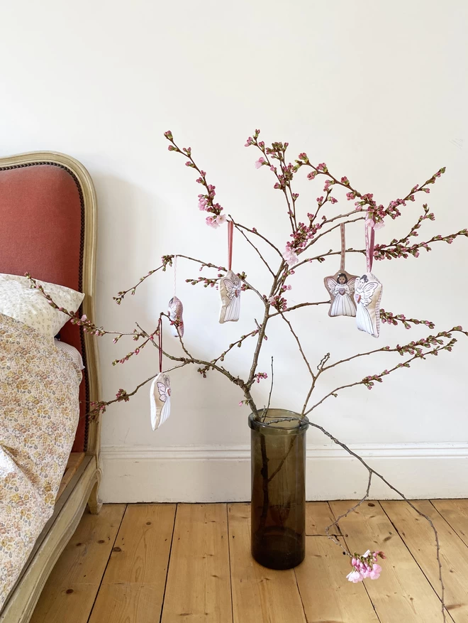 blossom branch next to pink bed