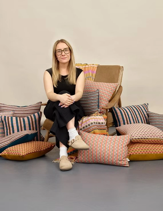 siobhan sitting on a chair surrounded by cushions