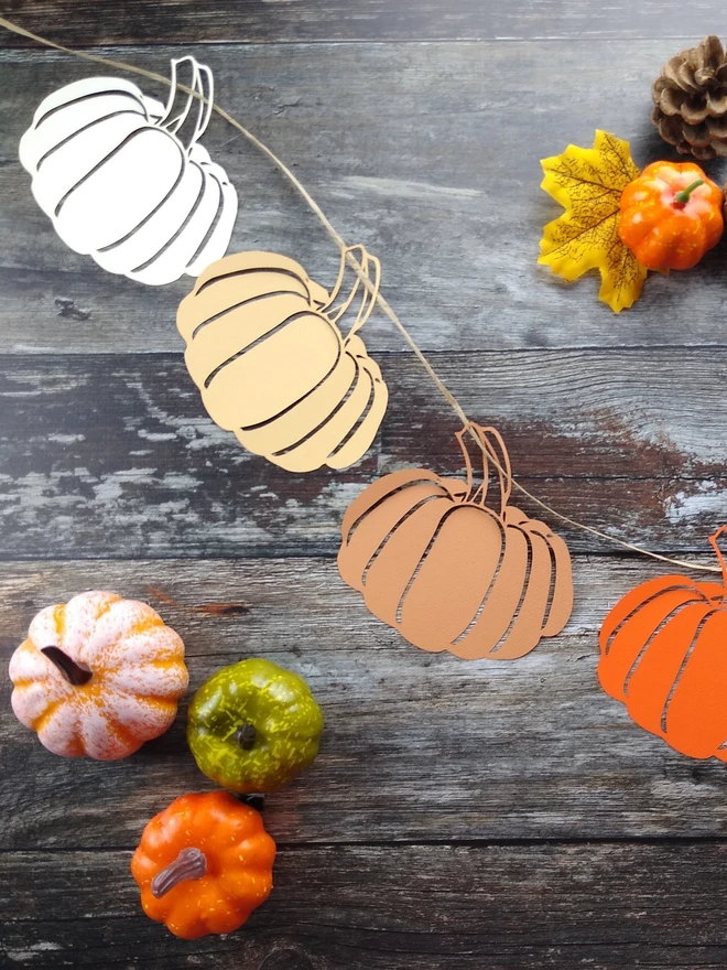 Paper Pumpkin Garland including 8 papercut pumpkins in cream, honey, cinnamon and orange