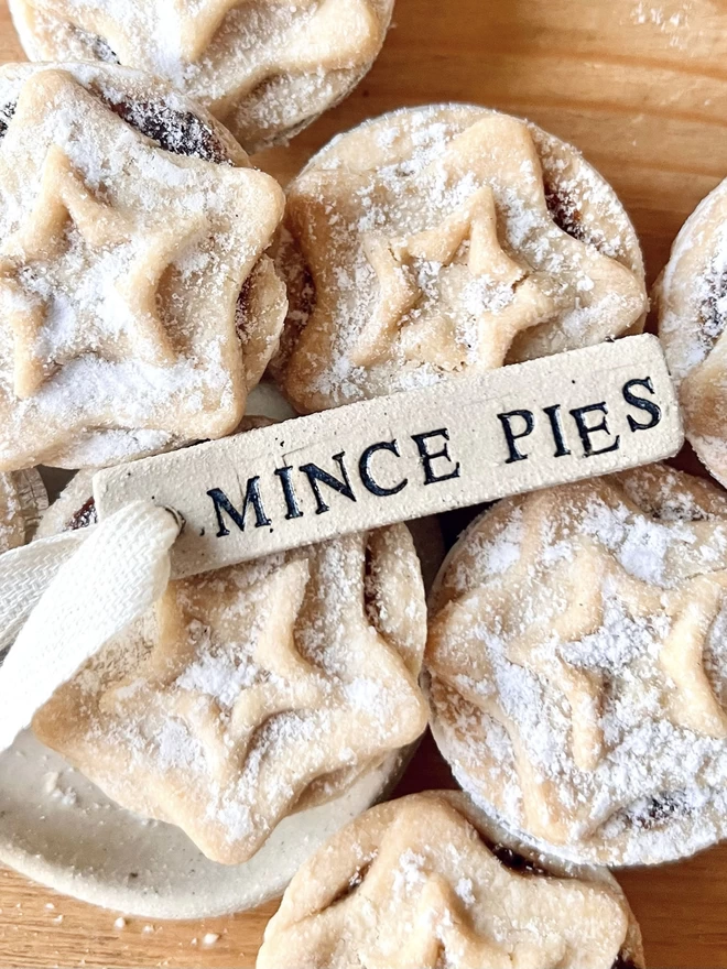 ceramic 'mince pies' tag, sat on top of a pile of mince pies