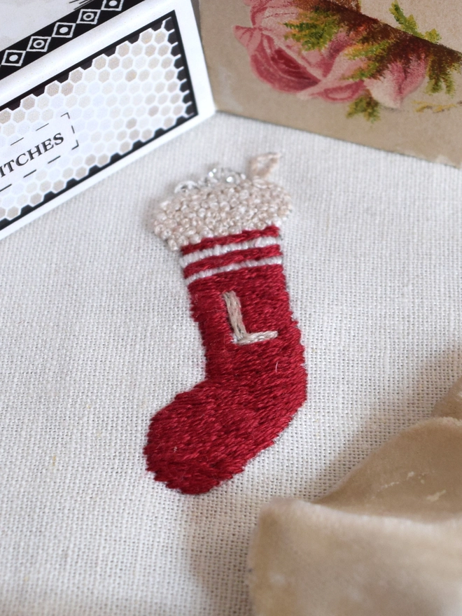 A single Christmas stocking with crystals bursting from the top.  Embroidered with an initial.  