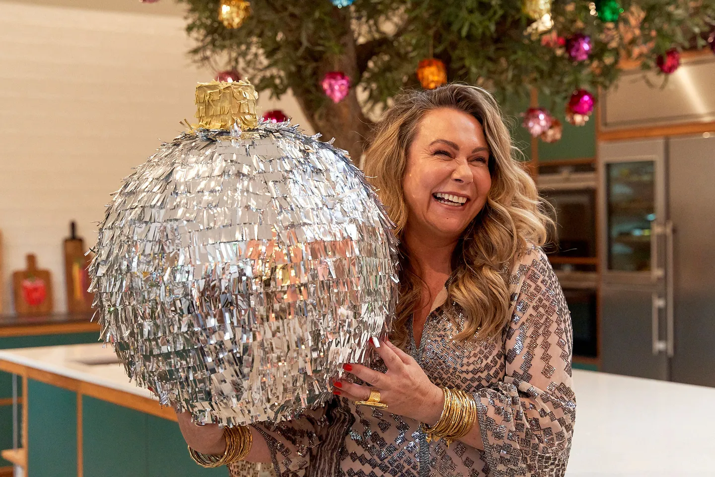 Christmas bauble pinata held in the air by Holly Tucker
