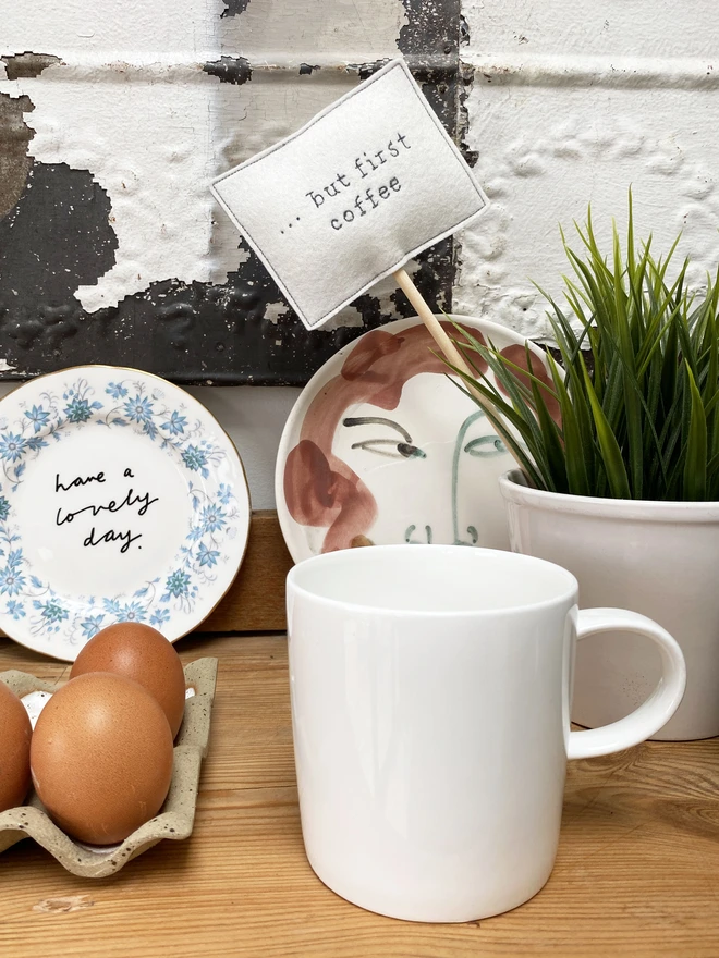 Coffee Embroidered Felt Sign in plant with mug and eggs