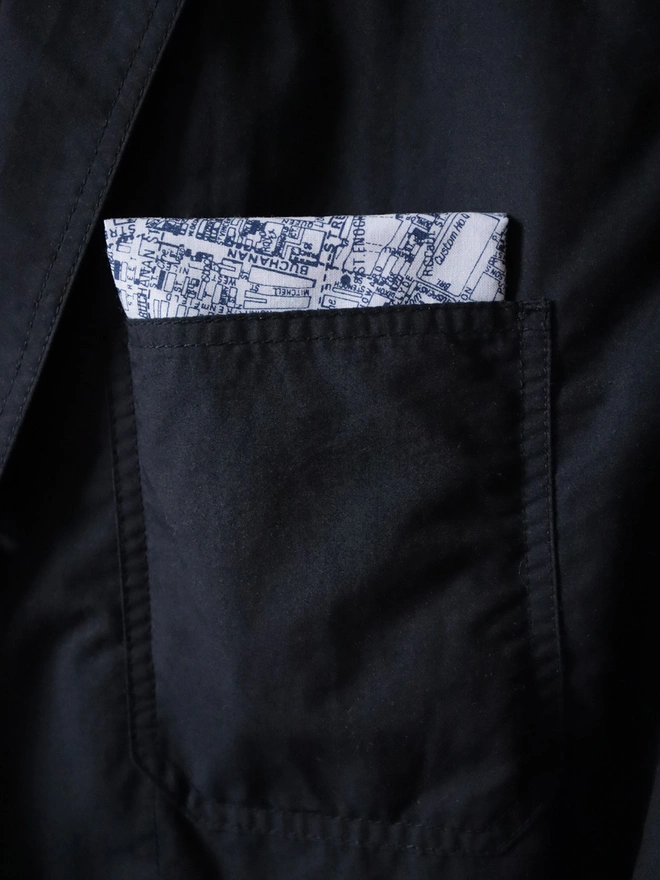 A Mr.PS Glasgow map handkerchief folded in a dark jacket pocket