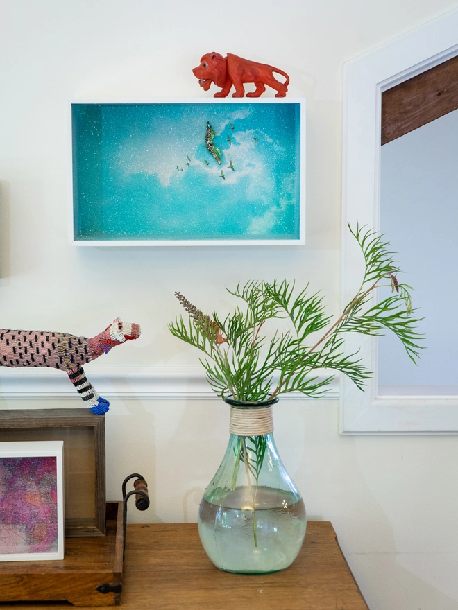  A Glass Cathedral artbox displayed in a home interior setting with other decorative objects 