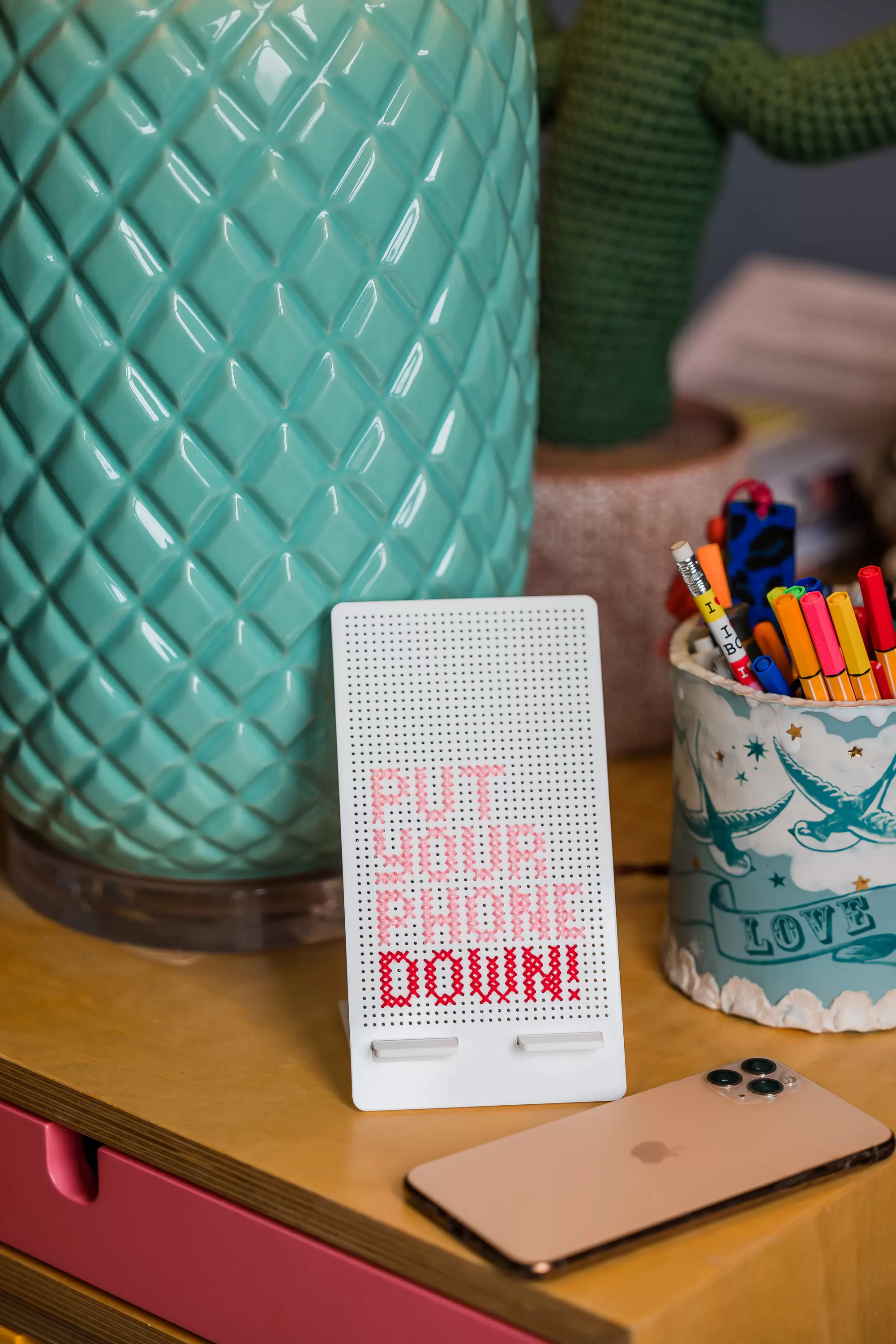 Put your phone down stand on a wooden desk 