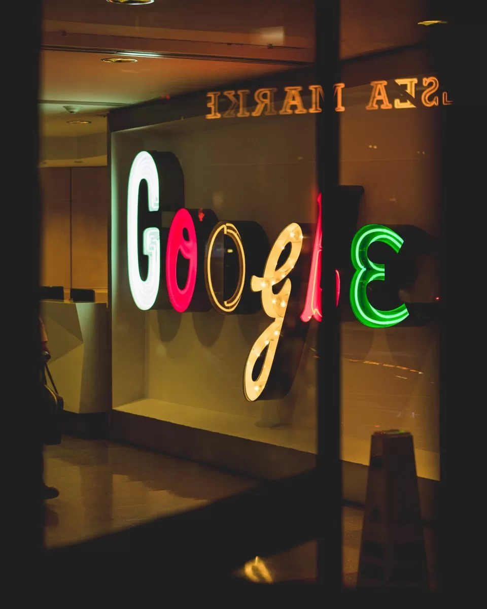 Illuminated multi-colour Google sign at office entrance 