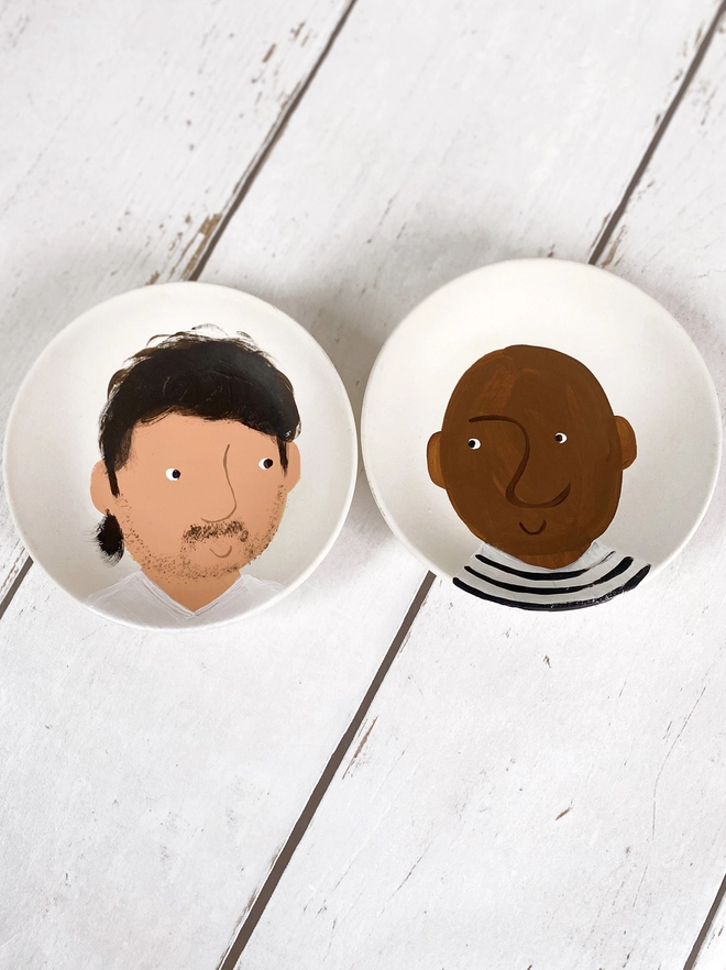two plates painted with portraits 