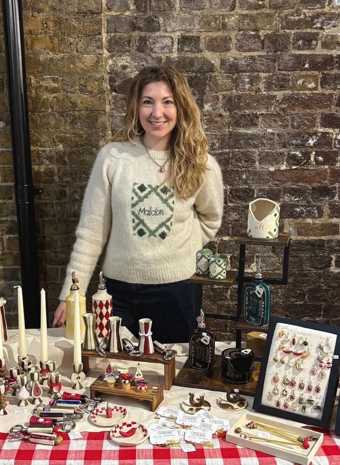 emily standing with a table of wem products