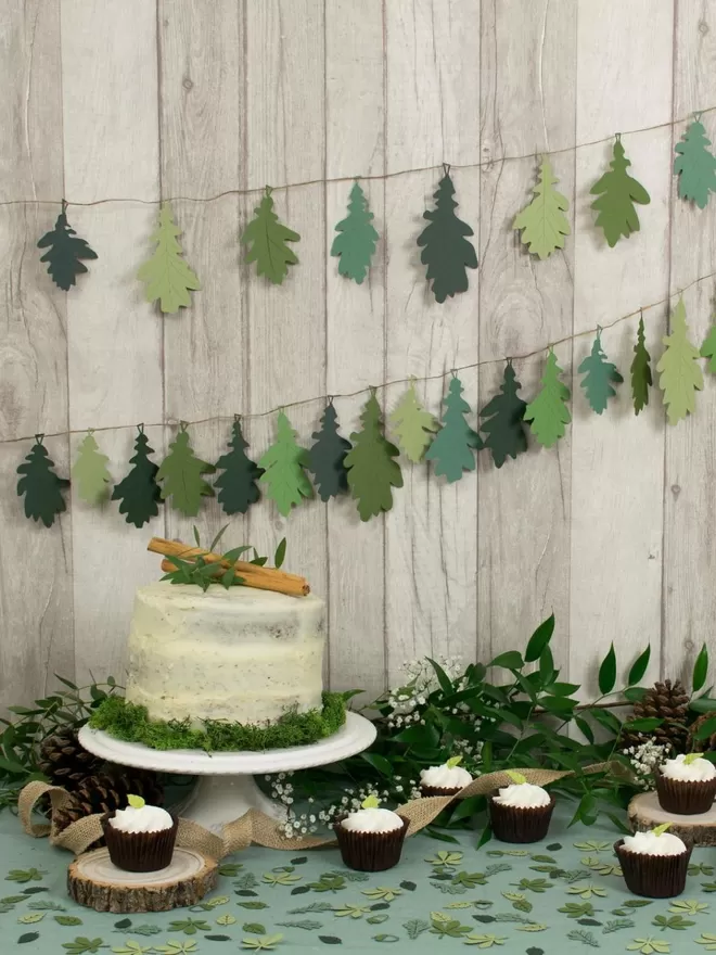 2 Green Oak Leaf Garlands (10 leaf and 20 leaf garlands)strung across a wall as a backdrop for a dessert buffet table.