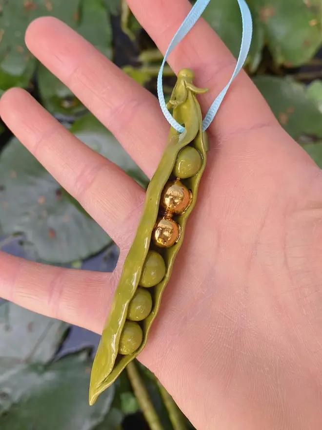 handmade ceramic peas in a pod christmas decoration with two gold peas