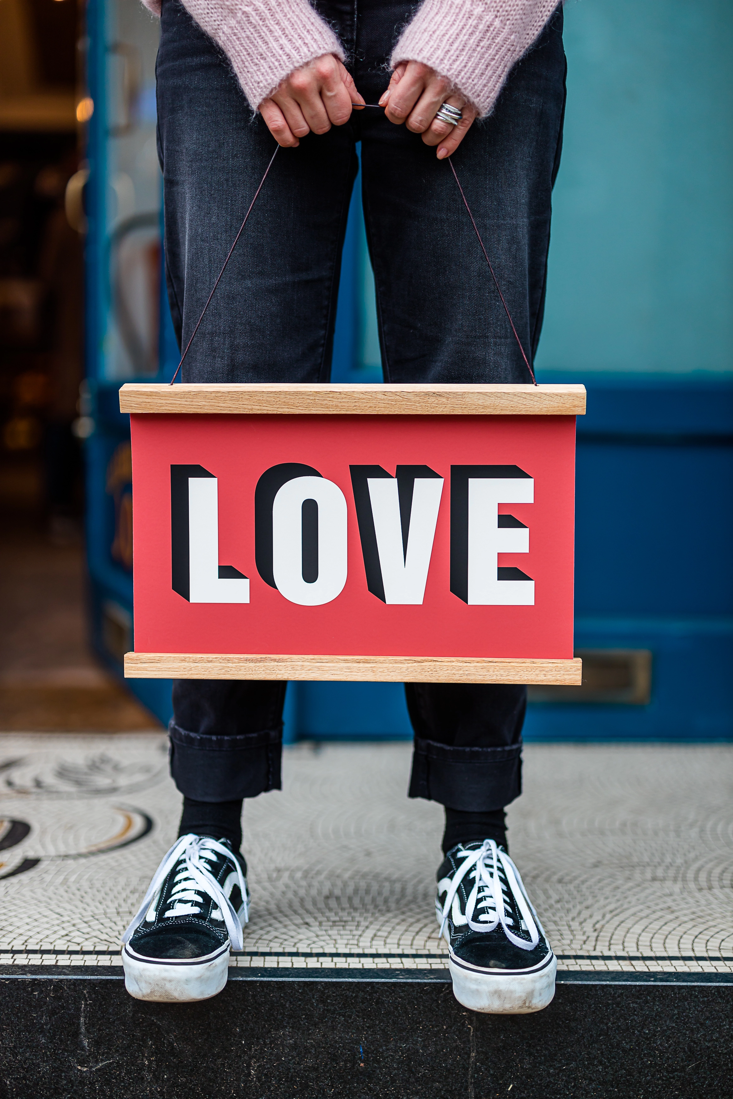Red sign that says 'Love' on it by Modo Creative