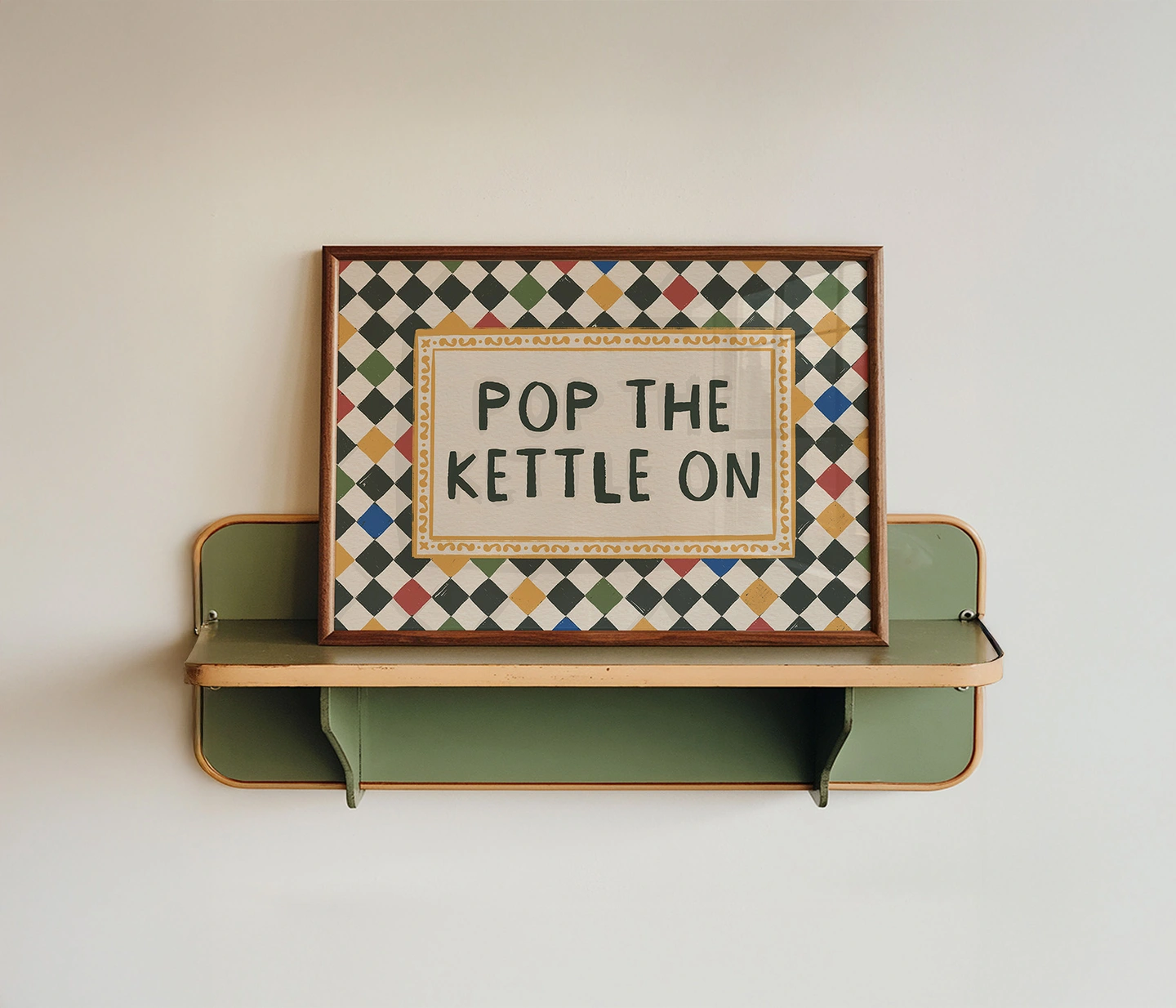 Pop the kettle on print. A print with pop the kettle on in the middle and a harlequin pattern border
