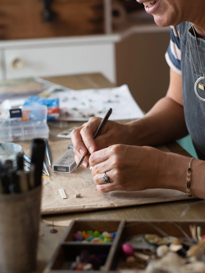 Lisa Swerling in her California art studio making a miniature circus-themed Glass Cathedral  for an exhibition at Anthropologie in 2019