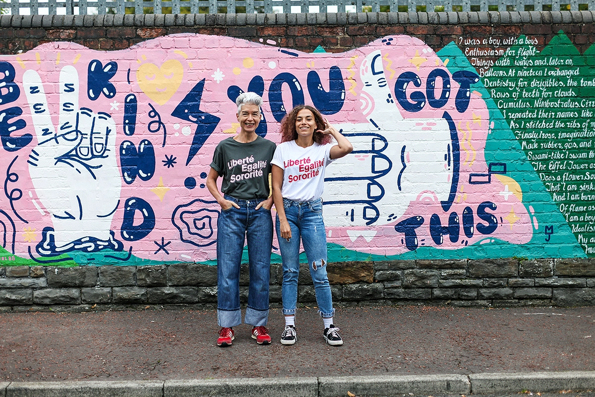 A white woman and a black women model Black & Beech's Liberté tee