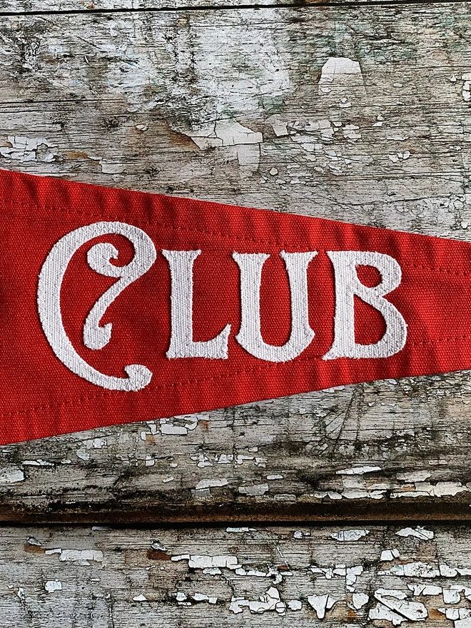 Detail of a red The true believers club pennant flag