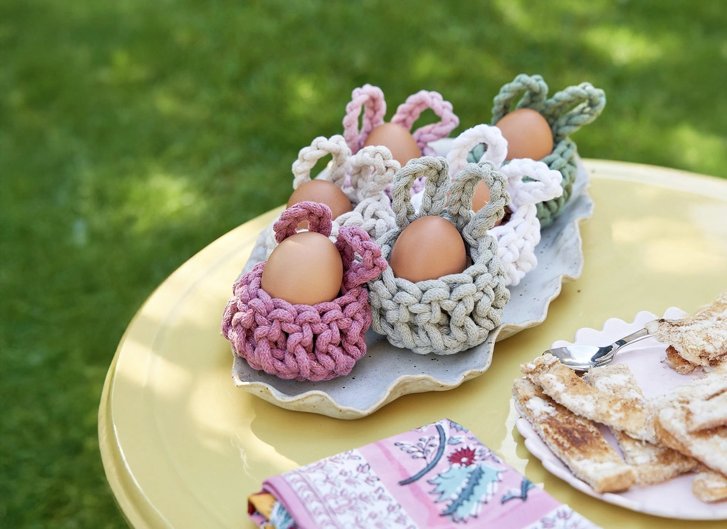 Crochet rabbit egg cups. Pastel coloured rabbit egg cups in the shape of a rabbit