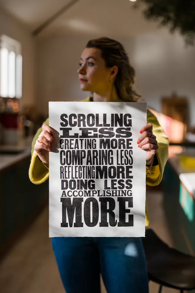 Woman holing a scrolling less poster 