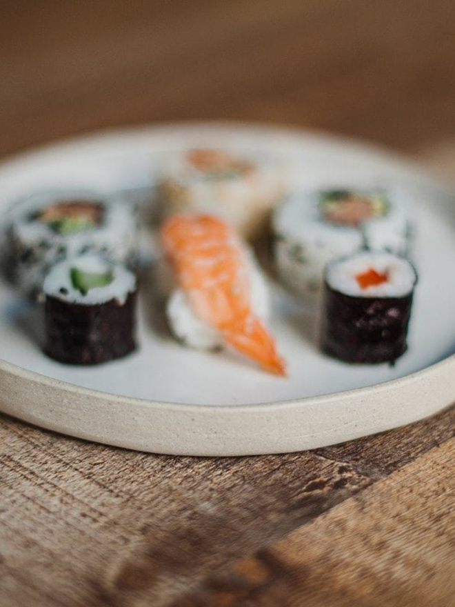 white ceramic dinner plate edge detail with sushi