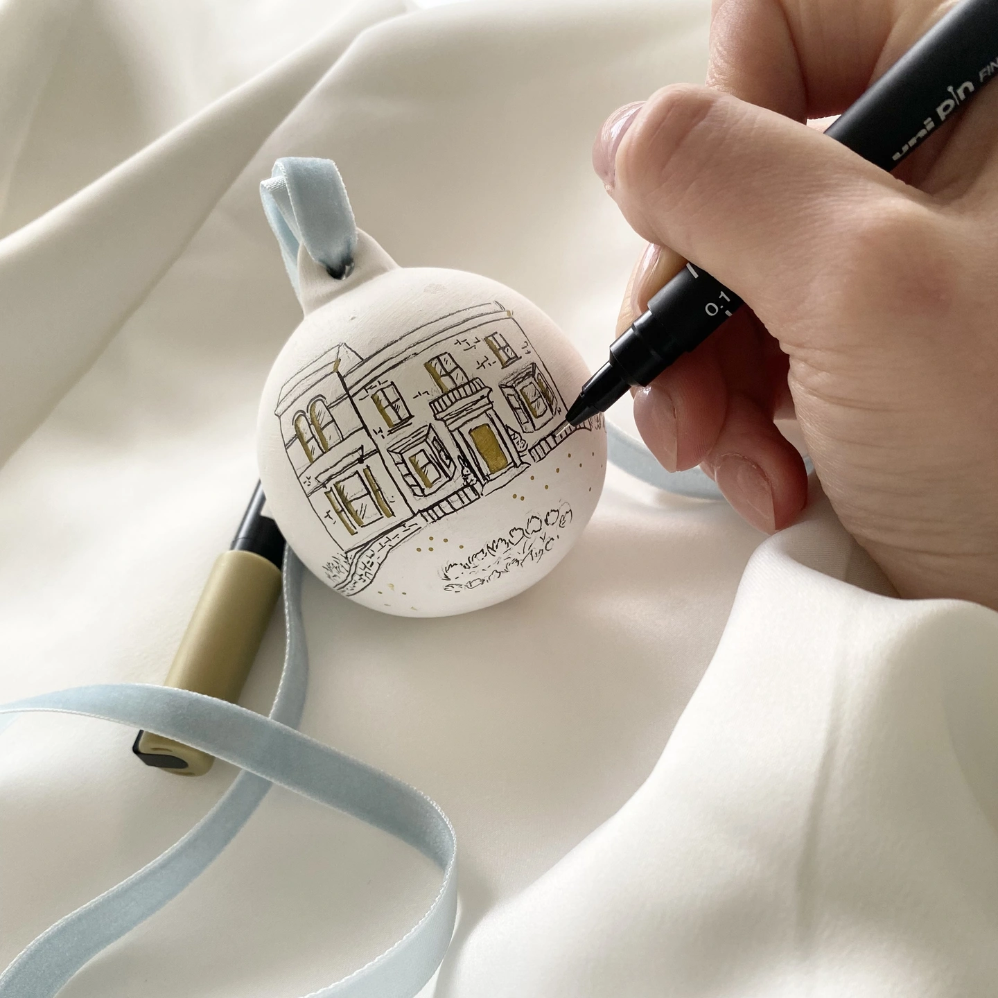 Drawing a ceramic bauble with black ink 