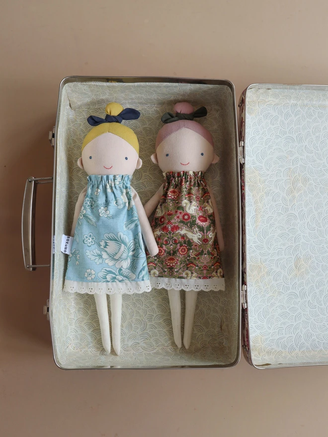 Cotton and linen doll with fair skin and blonde hair, wearing vintage inspired flower print in blue.