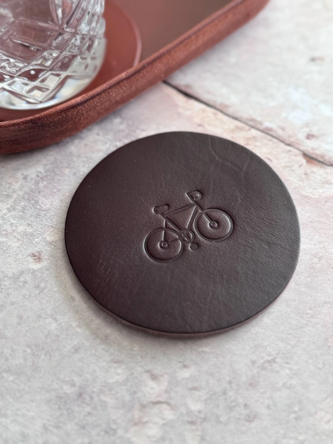 Leather coaster with bike deboss