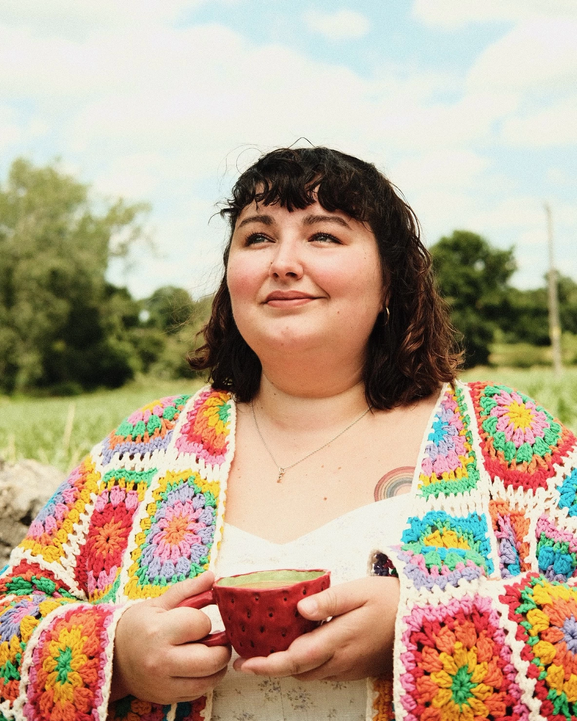 woman holding a handmade strawberry mug 