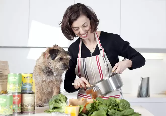 Henrietta Morrison, founder of Lily's Kitchen, cooking with her dog 