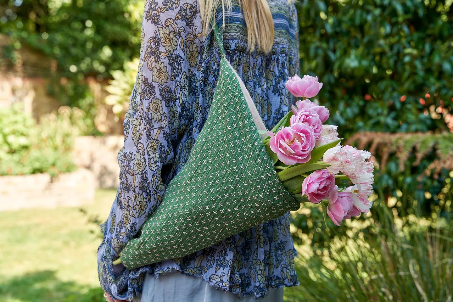 Reusable linen flower bag. A green embroidered bag with a bouquet of tulips.