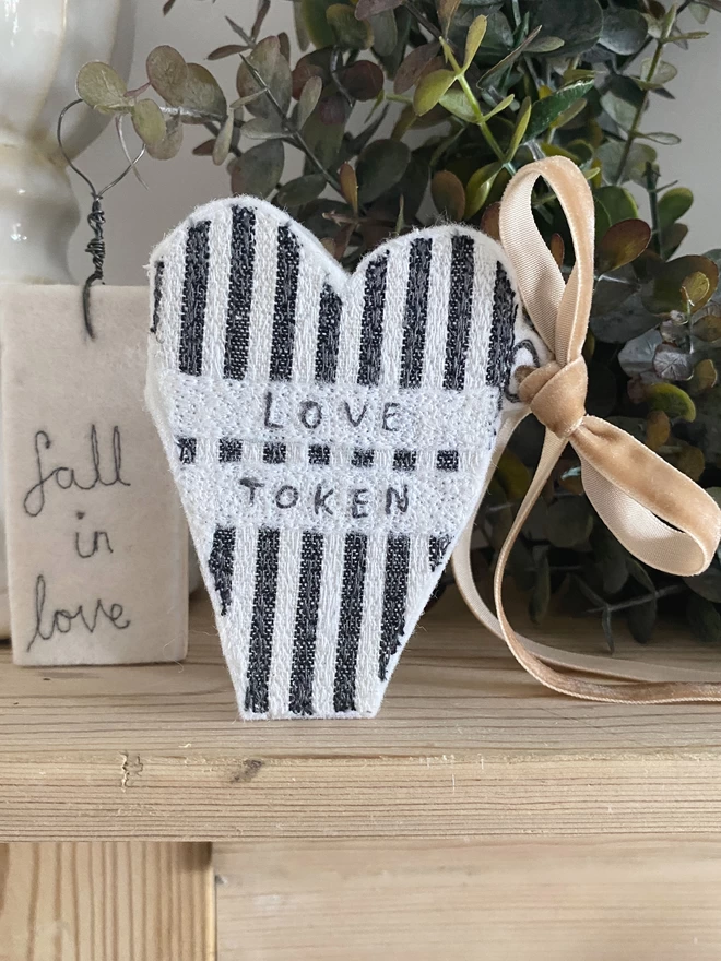 love token on fireplace with wreath
