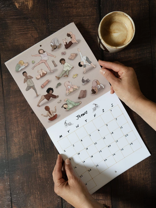 a calendar open showing the month June, children doing yoga and squares for writing