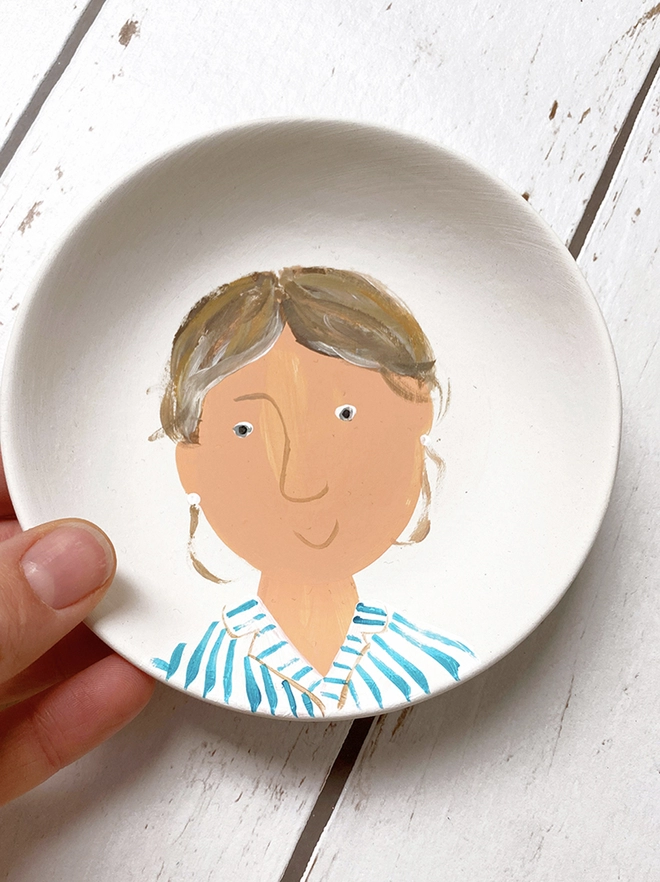 hand painted plate portrait of lady with striped shirt