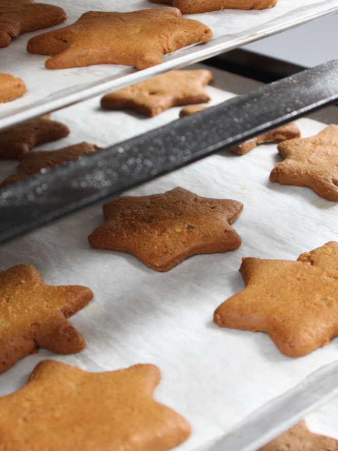 artisan gingerbread star biscuits on baking tray