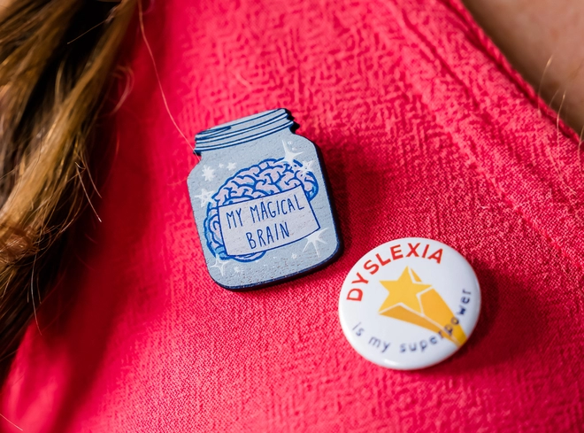 Badges that say 'my magical brain' and 'dyslexia is my superpower'