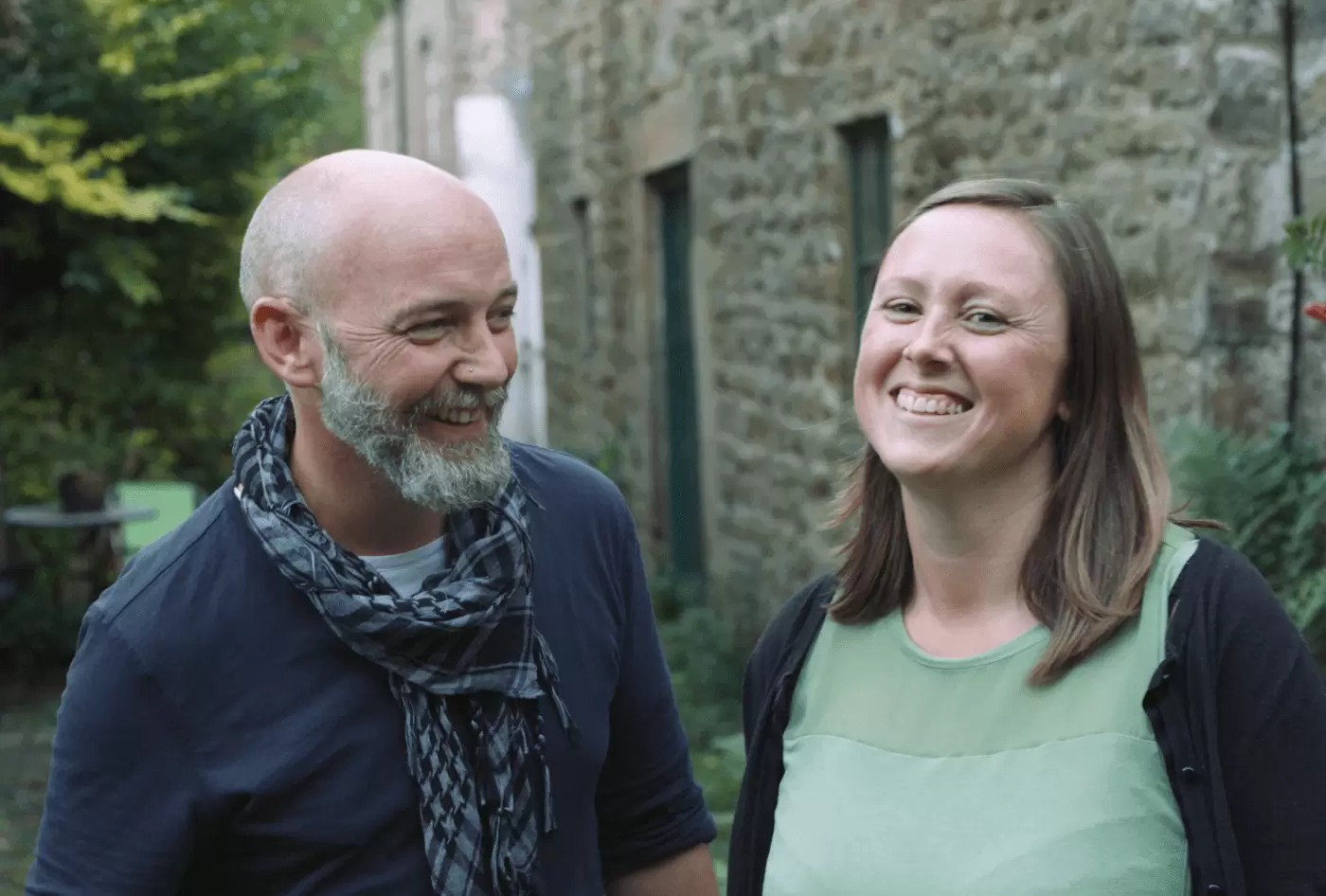 Bread & Jam founders standing outside a stone building 