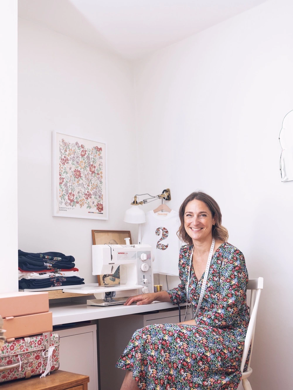 Becky the owner of Magnificent Stanley sitting at her sewing machine in her studio